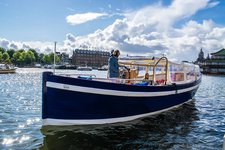Discover Amsterdam  in style boating on this electric boat rental
